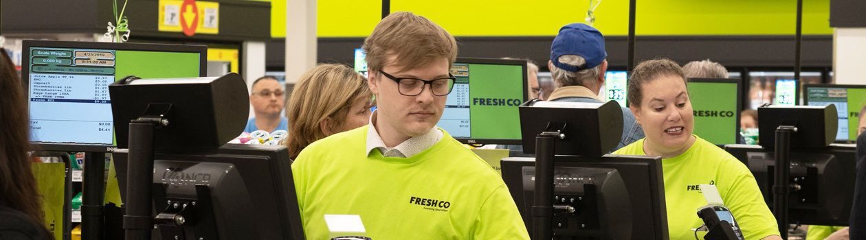 Multiple freshco cashiers checking out customers items